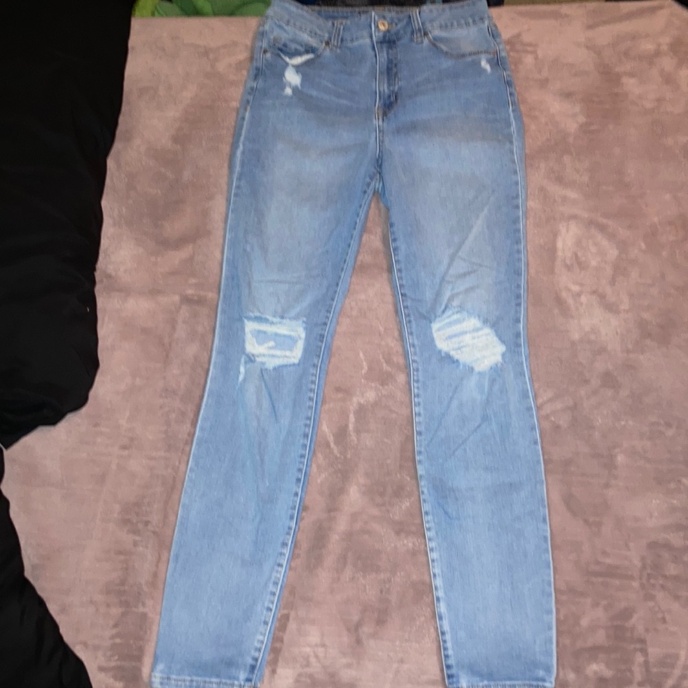 They’re light blue jeans with a ripped style on the knees. They need a new home.